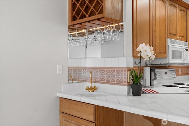 6903 Fauntleroy Way SW, Seattle, WA 98136 - kitchen featuring white appliances, backsplash, and tile countertops