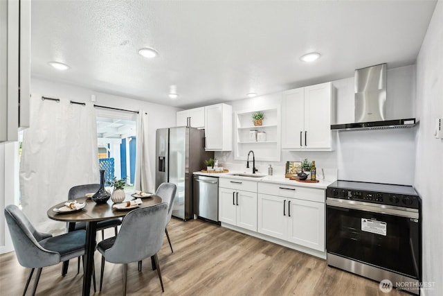 4715 S Cushman Ave, Tacoma, WA 98408 - kitchen with wall chimney range hood, appliances with stainless steel finishes, open shelves, white cabinets, and light countertops