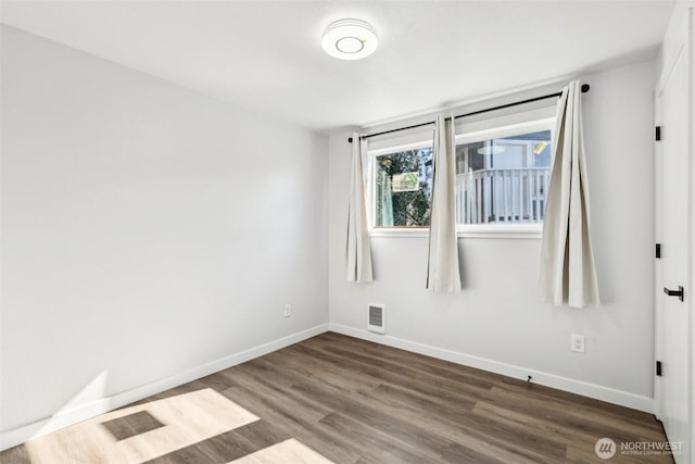 4715 S Cushman Ave, Tacoma, WA 98408 - spare room featuring dark wood-style floors and baseboards