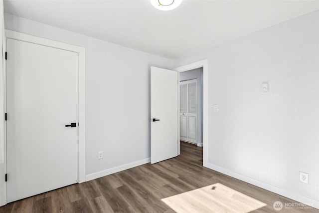 4715 S Cushman Ave, Tacoma, WA 98408 - unfurnished bedroom featuring wood finished floors and baseboards