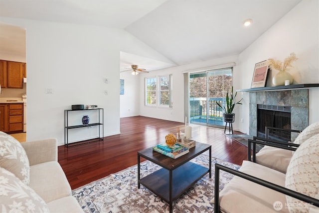 5813 S 238th Ct Unit F2, Kent, WA 98032 - living room featuring wood finished floors, vaulted ceiling, a tile fireplace, and a ceiling fan