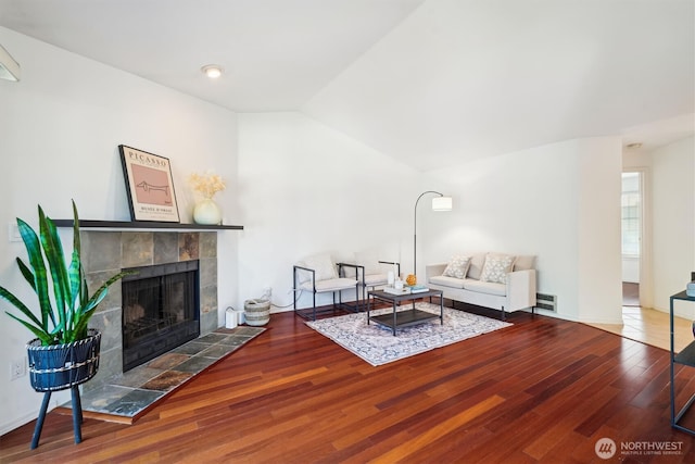 5813 S 238th Ct Unit F2, Kent, WA 98032 - living room with wood finished floors, a tiled fireplace, and lofted ceiling