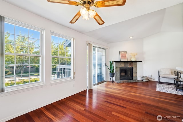 5813 S 238th Ct Unit F2, Kent, WA 98032 - unfurnished living room with vaulted ceiling, wood finished floors, a tile fireplace, and a ceiling fan
