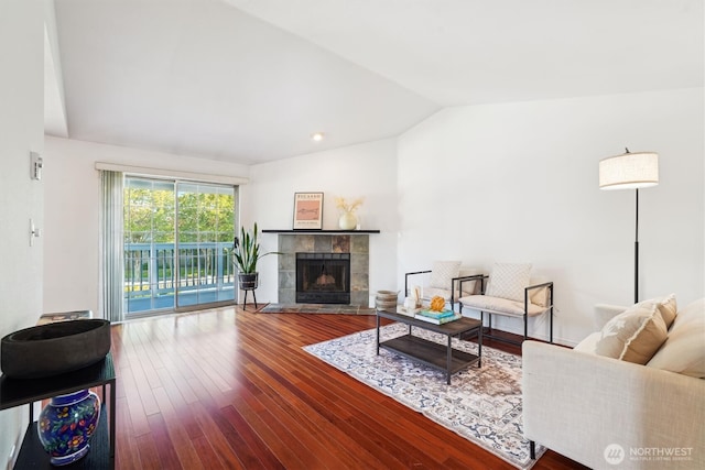 5813 S 238th Ct Unit F2, Kent, WA 98032 - living area featuring lofted ceiling, hardwood / wood-style flooring, and a tiled fireplace