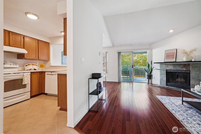 5813 S 238th Ct Unit F2, Kent, WA 98032 - kitchen featuring white appliances, open floor plan, light countertops, a fireplace, and brown cabinets