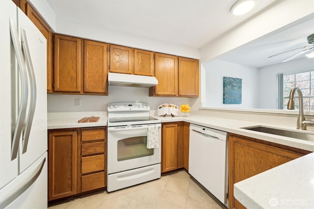 5813 S 238th Ct Unit F2, Kent, WA 98032 - kitchen with white appliances, under cabinet range hood, and brown cabinetry