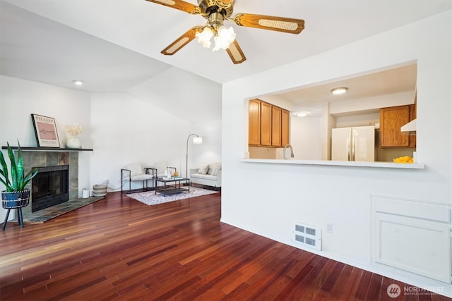 5813 S 238th Ct Unit F2, Kent, WA 98032 - living area featuring wood finished floors, a ceiling fan, vaulted ceiling, and a tile fireplace