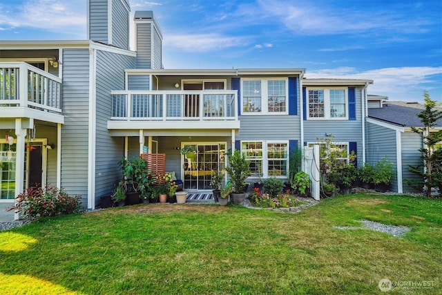 5813 S 238th Ct Unit F2, Kent, WA 98032 - back of property with a chimney, a lawn, and a balcony