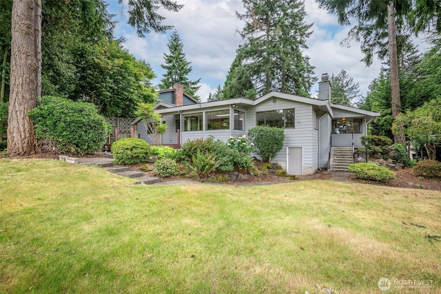 3524 SW 325th St, Federal Way, WA 98023 - view of home's exterior with a chimney, stairway, a lawn, and a sunroom
