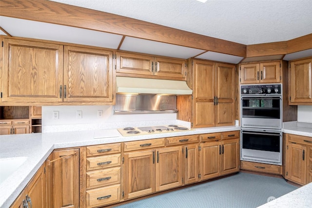 3524 SW 325th St, Federal Way, WA 98023 - kitchen featuring white appliances, under cabinet range hood, light countertops, brown cabinetry, and a textured ceiling
