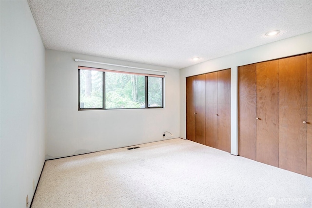3524 SW 325th St, Federal Way, WA 98023 - unfurnished bedroom with multiple closets, carpet floors, a textured ceiling, and recessed lighting