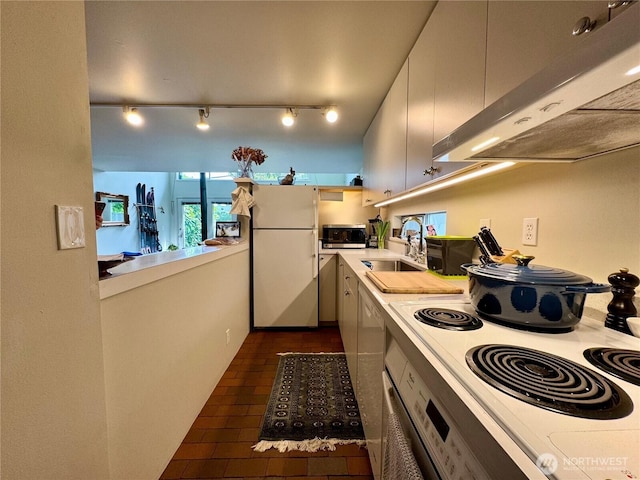 716 N 42nd St, Seattle, WA 98103 - kitchen with freestanding refrigerator, under cabinet range hood, stainless steel microwave, range with electric stovetop, and light countertops