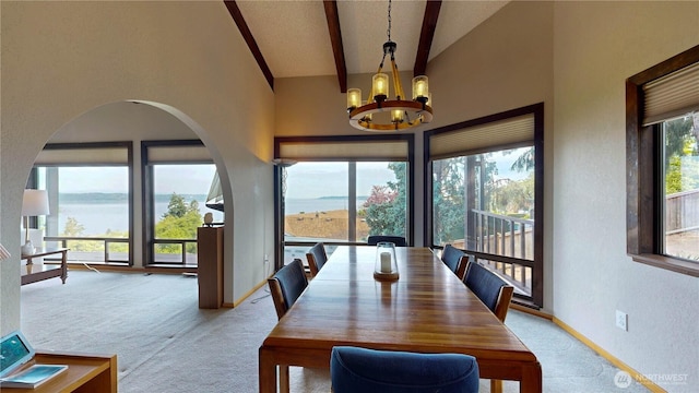 29417 1st Ave S, Federal Way, WA 98003 - carpeted dining space with a chandelier, a water view, beamed ceiling, high vaulted ceiling, and a textured wall