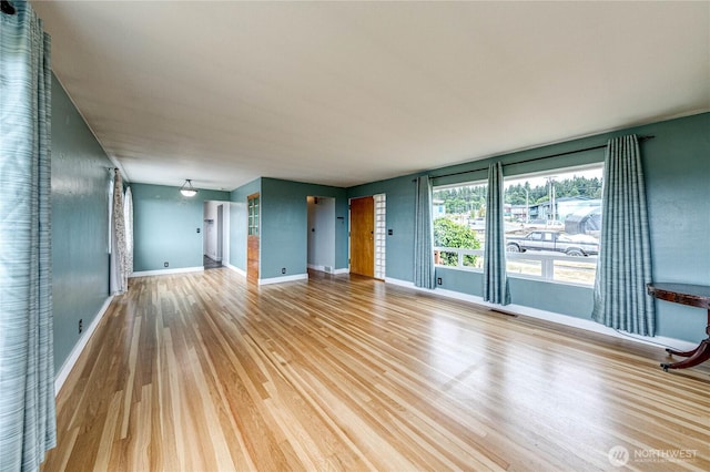 727 E 11th St, Port Angeles, WA 98362 - unfurnished living room with wood finished floors and baseboards