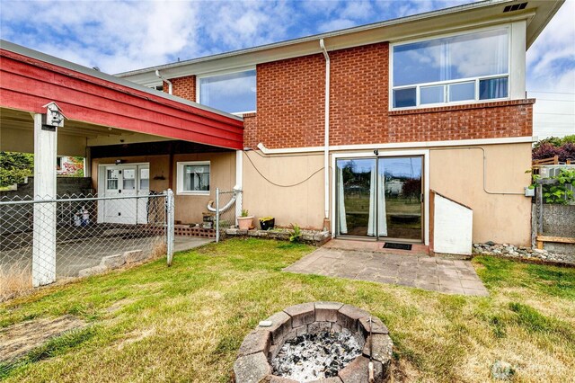 727 E 11th St, Port Angeles, WA 98362 - back of house featuring a patio, brick siding, stucco siding, and a fire pit