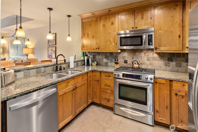3770 Suncadia Trl Unit 309, Cle Elum, WA 98922 - kitchen with appliances with stainless steel finishes, decorative backsplash, light tile patterned floors, and brown cabinetry