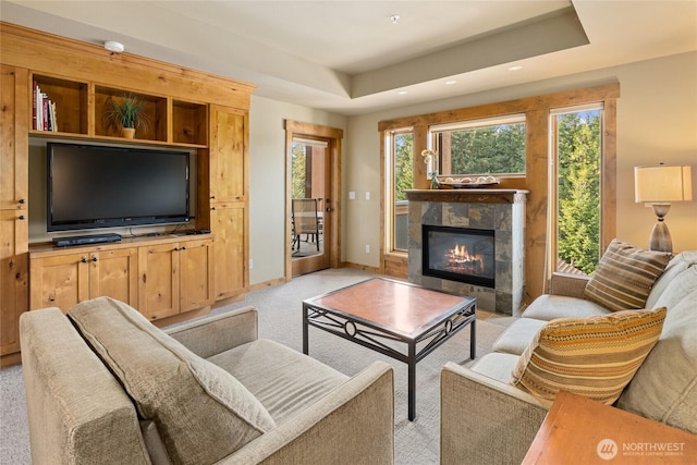 3770 Suncadia Trl Unit 309, Cle Elum, WA 98922 - living area with light colored carpet, a tile fireplace, recessed lighting, and a tray ceiling