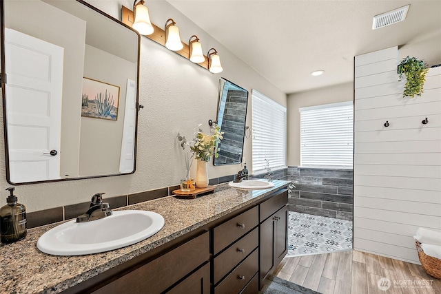 19537 207th Street Ct E, Orting, WA 98360 - full bath featuring double vanity, wood finished floors, and walk in shower