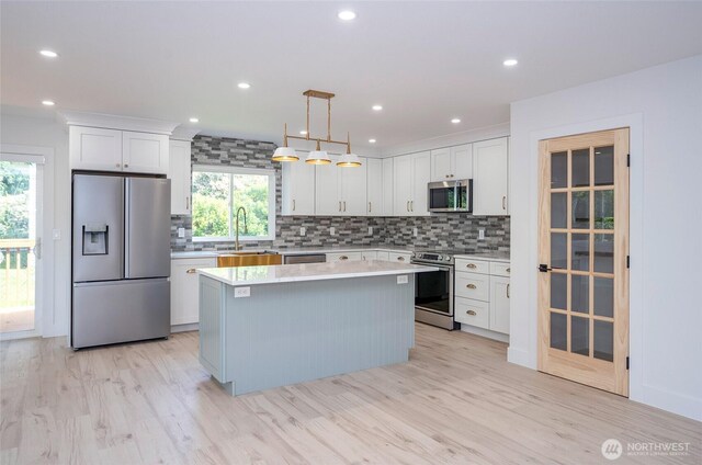 6203 119th St E, Puyallup, WA 98373 - kitchen with stainless steel appliances, healthy amount of natural light, light countertops, backsplash, and recessed lighting