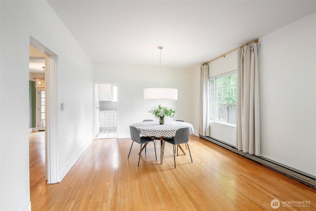406 N Cushman Ave, Tacoma, WA 98403 - dining room with a baseboard heating unit and light wood-style flooring