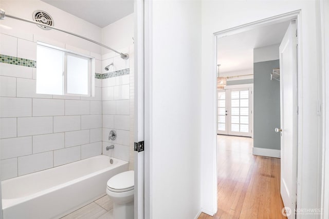 406 N Cushman Ave, Tacoma, WA 98403 - bathroom featuring shower / bathtub combination and wood finished floors