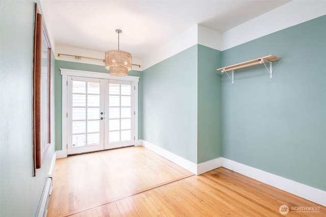 406 N Cushman Ave, Tacoma, WA 98403 - unfurnished dining area featuring wood finished floors, a chandelier, and french doors