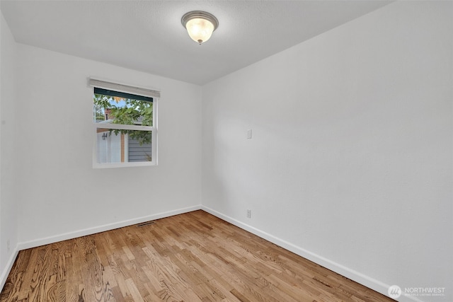 1310 23rd St SE, Auburn, WA 98002 - unfurnished room featuring baseboards and wood finished floors