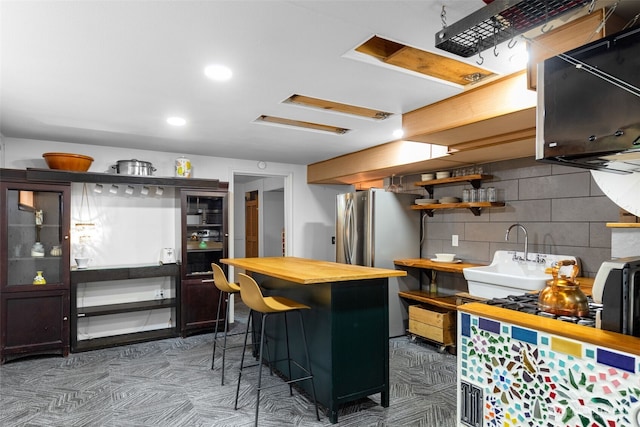 11803 14th Ave S, Seattle, WA 98168 - kitchen featuring butcher block counters, freestanding refrigerator, open shelves, recessed lighting, and a breakfast bar area