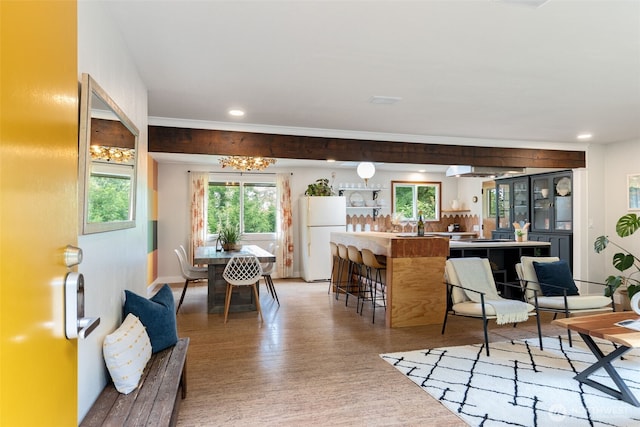 11803 14th Ave S, Seattle, WA 98168 - kitchen with freestanding refrigerator, light wood-style flooring, recessed lighting, a chandelier, and a breakfast bar area