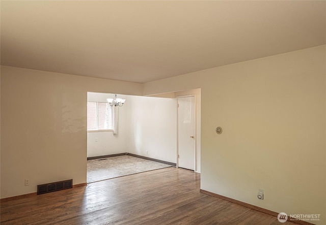 13049 35th Ave NE, Seattle, WA 98125 - spare room with a chandelier and wood finished floors