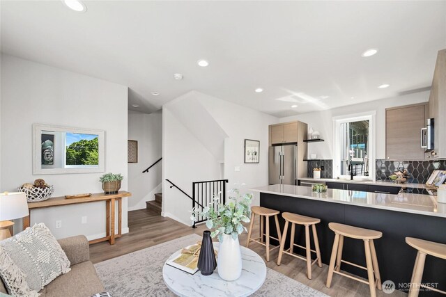 2817 Franklin Ave E Unit B, Seattle, WA 98102 - living room with light wood-style floors, stairs, and recessed lighting