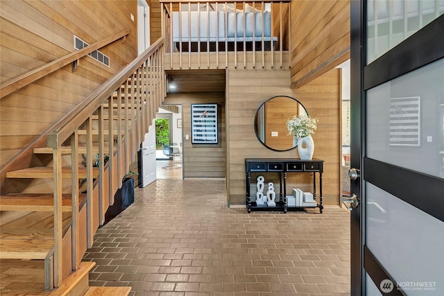 9101 SE 57th St, Mercer Island, WA 98040 - entrance foyer featuring wooden walls, brick floors, and stairs