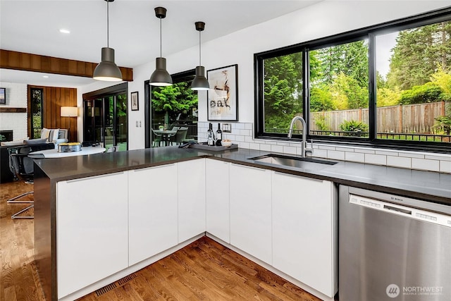9101 SE 57th St, Mercer Island, WA 98040 - kitchen with stainless steel dishwasher, a peninsula, white cabinetry, tasteful backsplash, and open floor plan