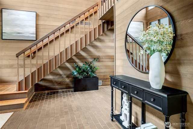 9101 SE 57th St, Mercer Island, WA 98040 - staircase featuring wood walls and brick patterned floors