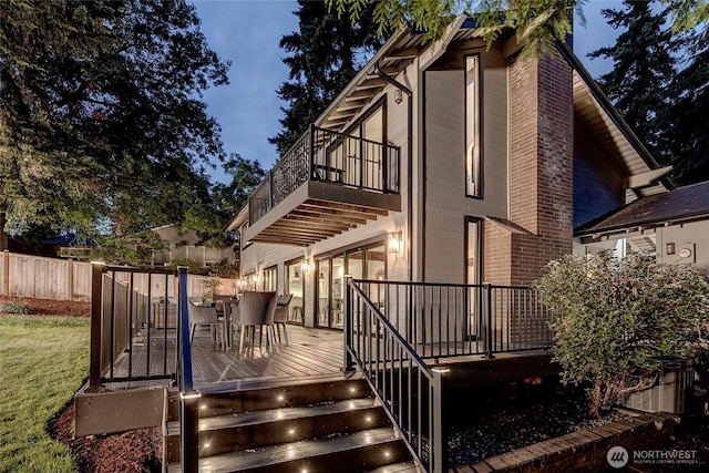 9101 SE 57th St, Mercer Island, WA 98040 - back of property featuring a balcony, brick siding, outdoor dining space, and a wooden deck