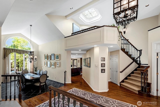 20821 NE 141st St, Woodinville, WA 98077 - dining space with wood finished floors, high vaulted ceiling, a chandelier, stairs, and beam ceiling