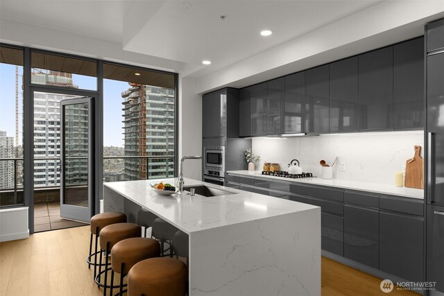 1808 Minor Ave Unit 3601, Seattle, WA 98101 - kitchen with modern cabinets, a breakfast bar, light wood finished floors, wine cooler, and gray cabinets