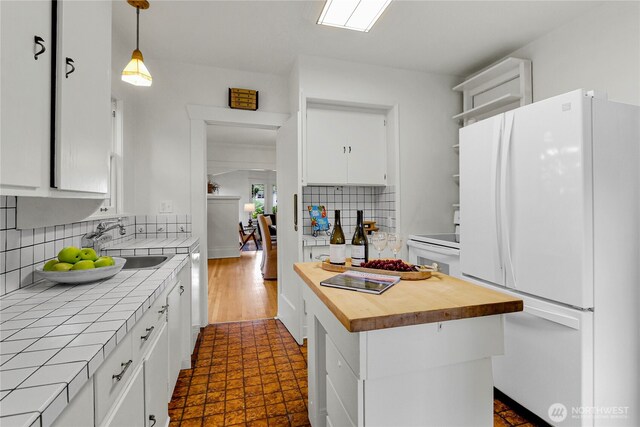 1523 4th Ave N, Seattle, WA 98109 - kitchen with white appliances, tile countertops, open shelves, a center island, and white cabinetry