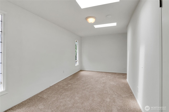 1523 4th Ave N, Seattle, WA 98109 - unfurnished room featuring a skylight, carpet flooring, and a smoke detector