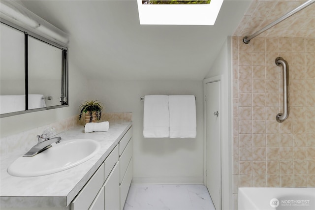 1523 4th Ave N, Seattle, WA 98109 - bathroom featuring vanity, a skylight, marble finish flooring, and shower / washtub combination