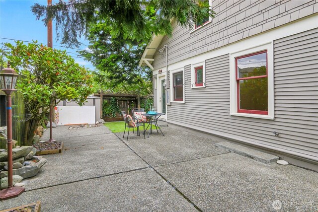 1523 4th Ave N, Seattle, WA 98109 - fenced backyard with outdoor dining space and a patio