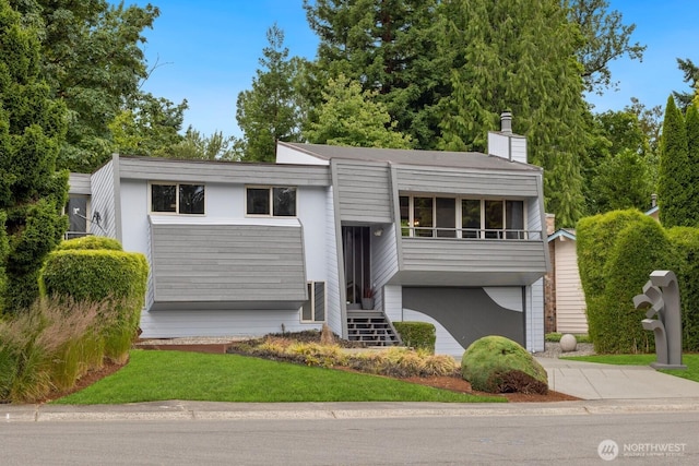 4983 120th Ave SE, Bellevue, WA 98006 - view of front of property featuring driveway, a chimney, a garage, and stucco siding