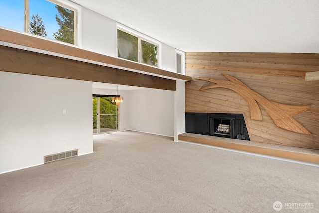 4983 120th Ave SE, Bellevue, WA 98006 - unfurnished living room with wood walls, a chandelier, carpet, and a fireplace with raised hearth