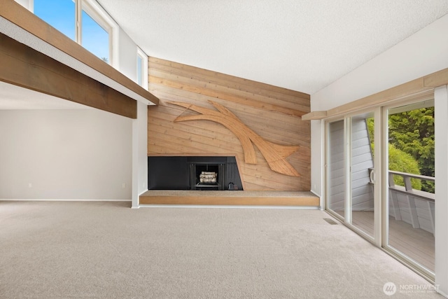 4983 120th Ave SE, Bellevue, WA 98006 - unfurnished living room with wood walls, a fireplace with raised hearth, carpet floors, and lofted ceiling