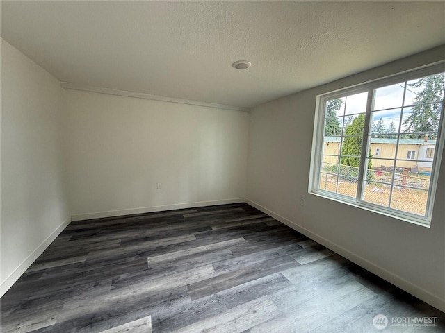 6411 201st Ave SW Unit 21, Centralia, WA 98531 - spare room with dark wood-style floors and a textured ceiling