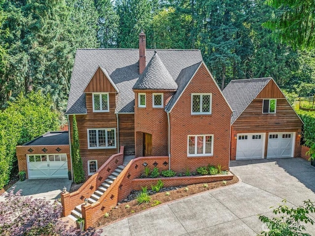 2608 Cascade Way, Longview, WA 98632 - view of front of property with a chimney, a garage, concrete driveway, board and batten siding, and a shingled roof