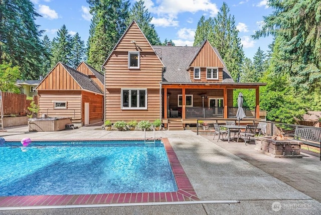 2608 Cascade Way, Longview, WA 98632 - view of swimming pool featuring an outdoor fire pit, a hot tub, a patio, and a wooden deck