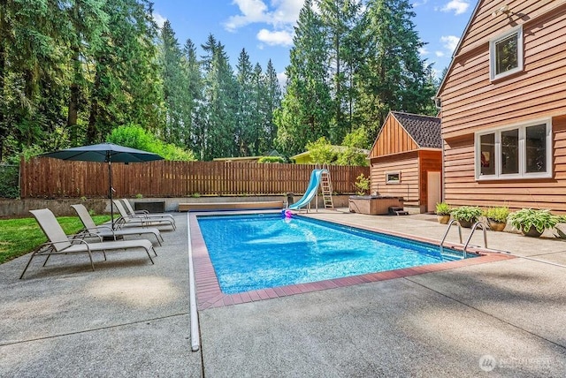 2608 Cascade Way, Longview, WA 98632 - view of pool featuring a water slide, a covered hot tub, a patio area, and a fenced backyard