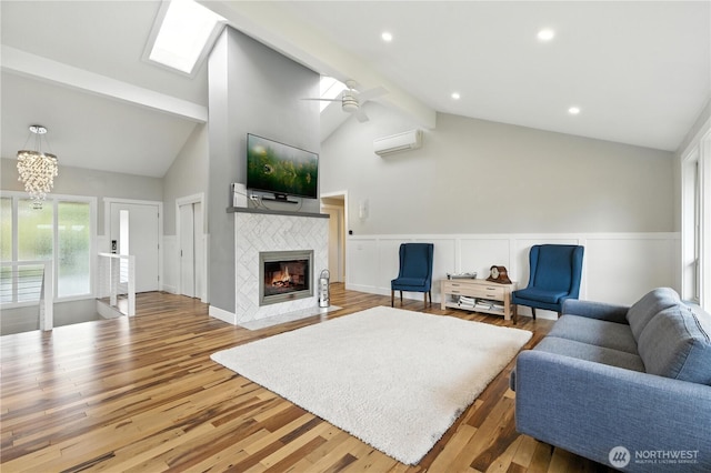 2500 171st Ave SE, Bellevue, WA 98008 - living area with a wall mounted AC, wood finished floors, a wainscoted wall, a ceiling fan, and a tile fireplace