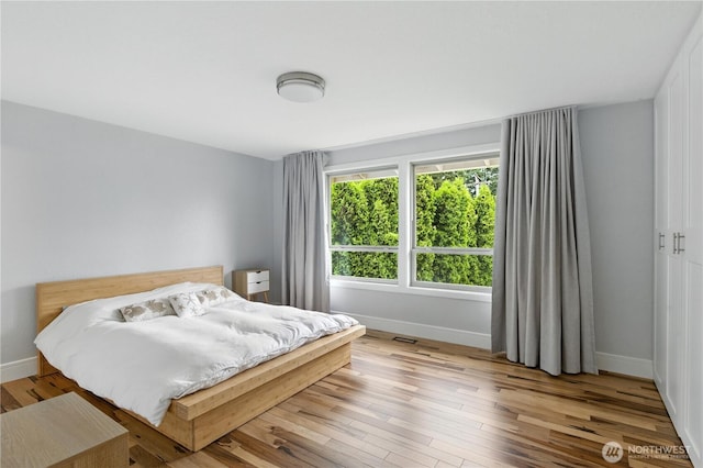 2500 171st Ave SE, Bellevue, WA 98008 - bedroom with baseboards and light wood-type flooring